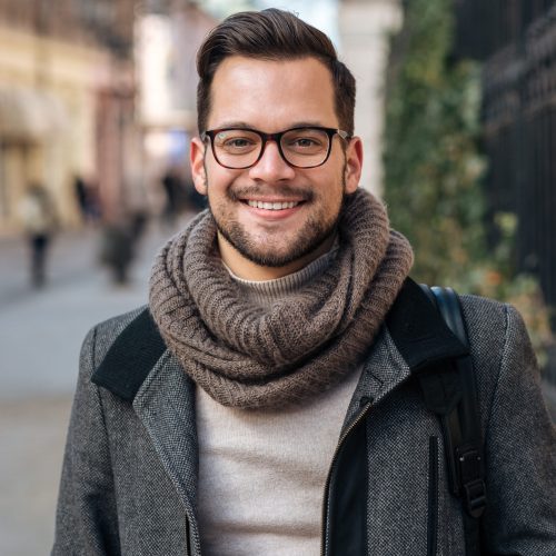 Winter portrait of young entrepreneur in the city.