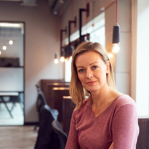 Head And Shoulders Portrait Of Mature Businesswoman  Working In Modern Office