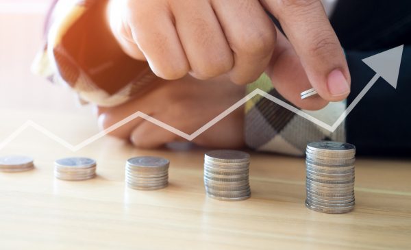 Woman putting coins on stack with holding money, Concept business, finance, money saving and investment